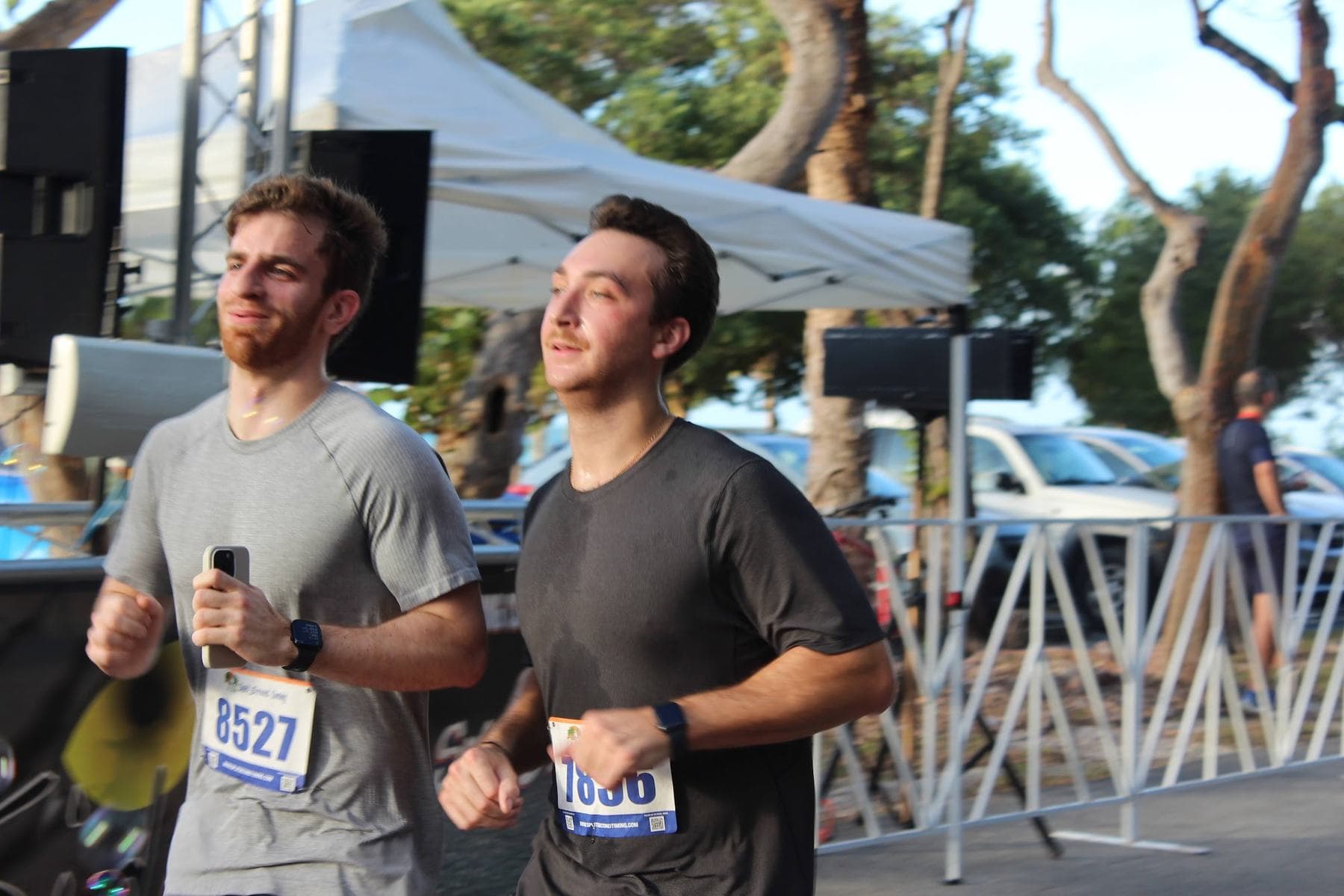 Two runners finishing side by side