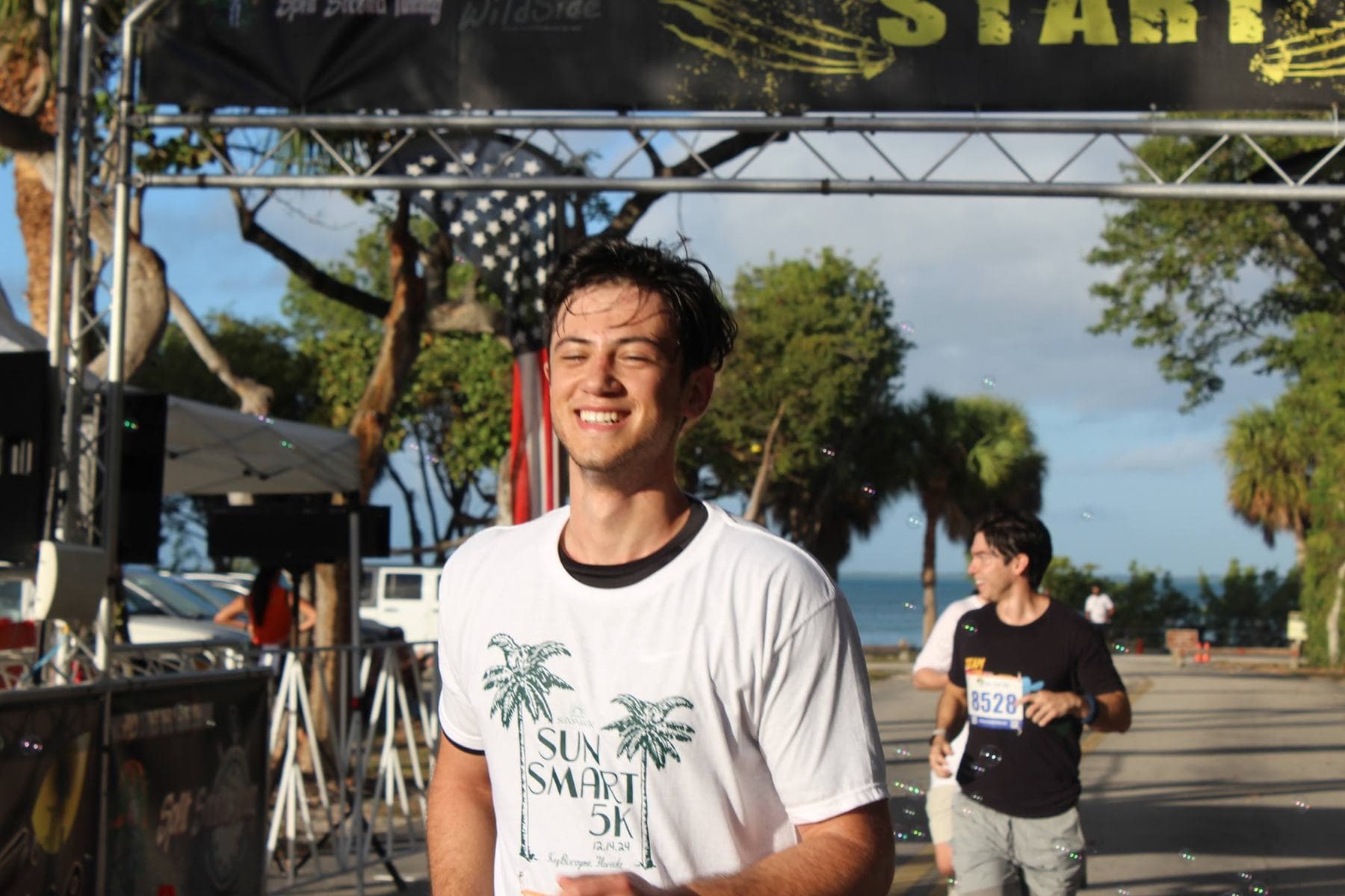 A runner grinning at the finish line
