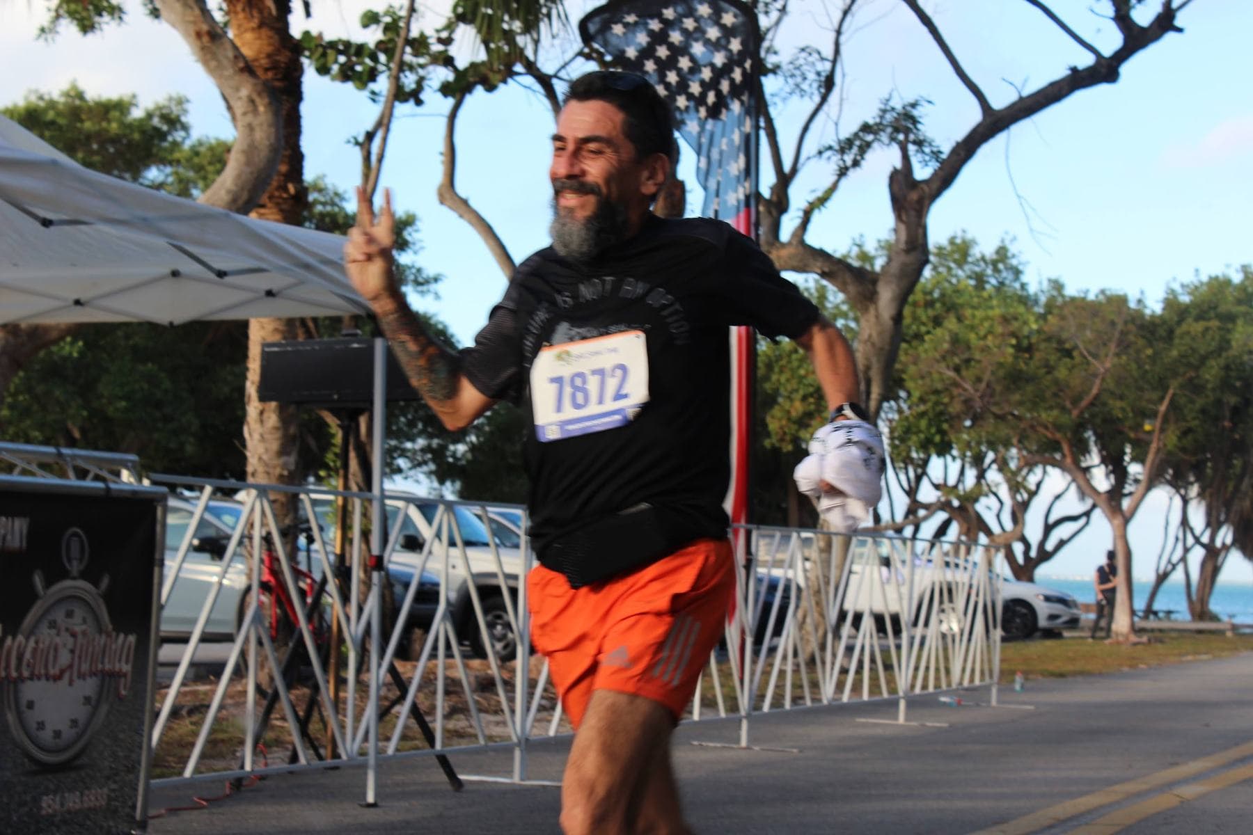 A runner in orange shorts approaching the finish