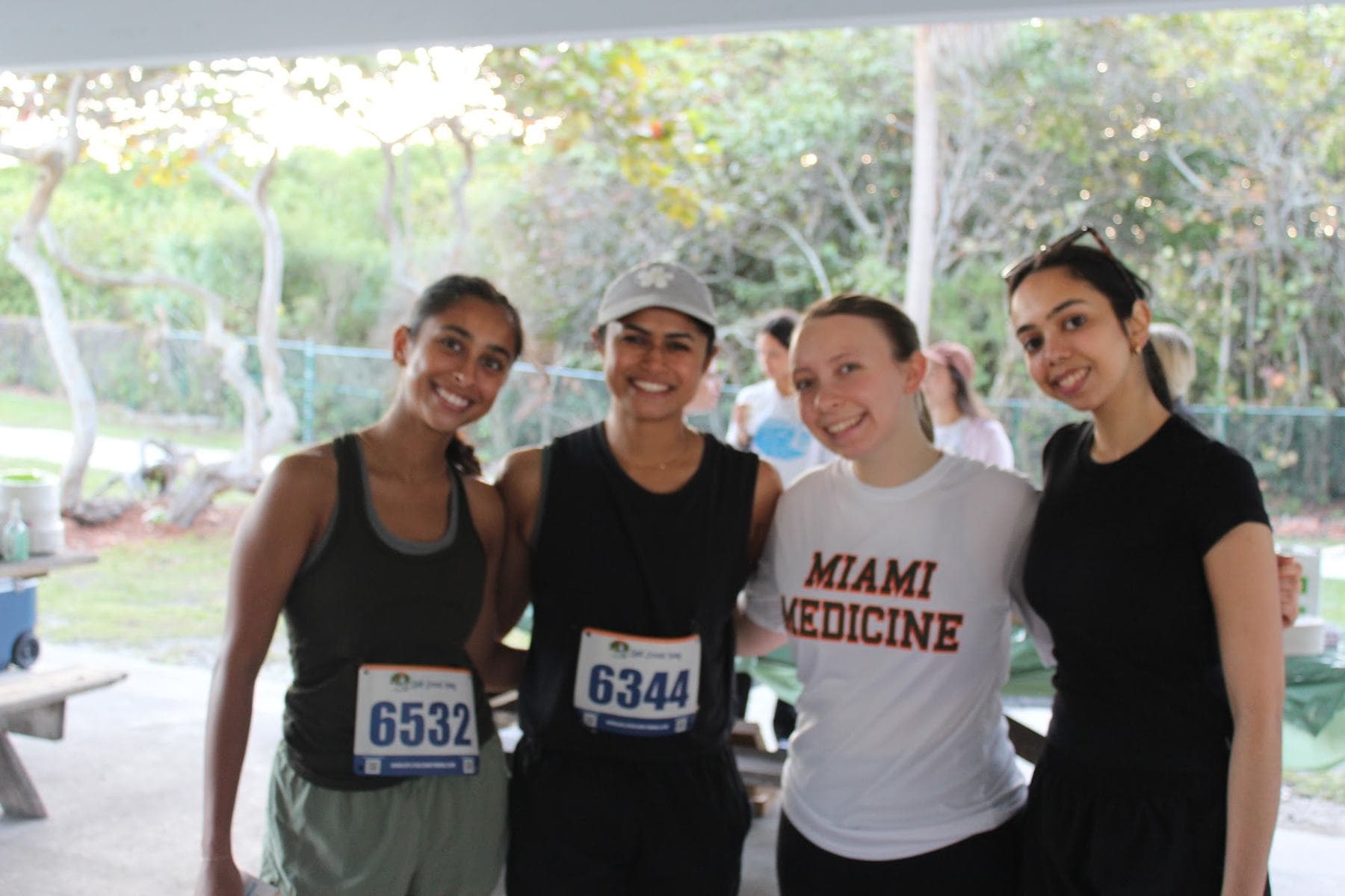 Four friends with their race bibs before the start